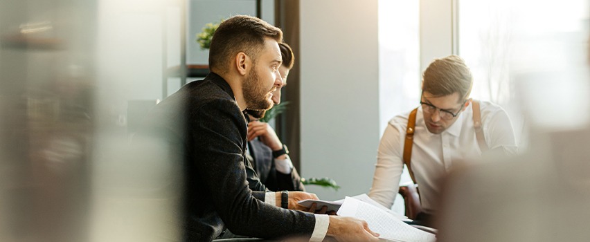 three male employees in a meeting